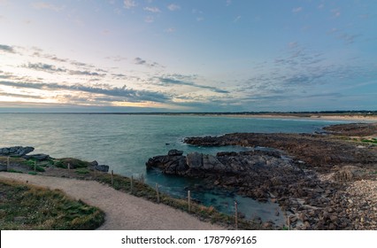 Long exposure with turquoise sea after sunset in summer at Pointe de la Torche, Plomeur, Finistère, Brittany, France.