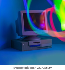 Long Exposure. Vintage PC In A Blue Room With Bold Graduated Colors. Red, Blue, Green, Yellow Color. Neon Colors, 90s Creative Minimal Nostalgic Concept. 