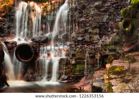 Long exposure water cascades from the upper portion of Shelving Rock Falls near the town of Fort Ann and Lake George in upstate New York, USA