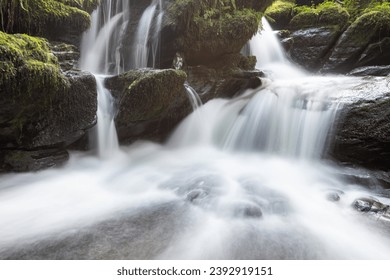 Long exposure of a waterfall on the Hoar Oak Water river at Watersmeet in Exmoor National Park - Shutterstock ID 2392919151