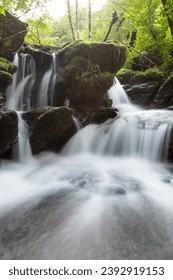 Long exposure of a waterfall on the Hoar Oak Water river at Watersmeet in Exmoor National Park - Shutterstock ID 2392919153
