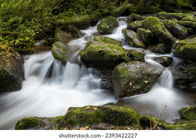 Long exposure of a waterfall on the Hoar Oak Water river at Watersmeet in Exmoor National Park - Shutterstock ID 2393422227