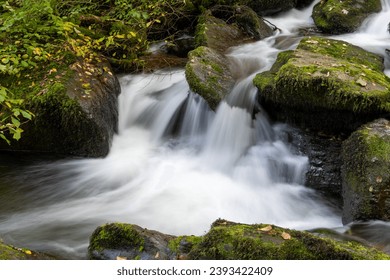 Long exposure of a waterfall on the Hoar Oak Water river at Watersmeet in Exmoor National Park - Shutterstock ID 2393422409