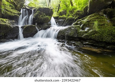Long exposure of a waterfall on the Hoar Oak Water river at Watersmeet in Exmoor National Park - Shutterstock ID 2393422467