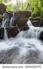 Long exposure of a waterfall on the Hoar Oak Water river at Watersmeet in Exmoor National Park - Shutterstock ID 2393422579