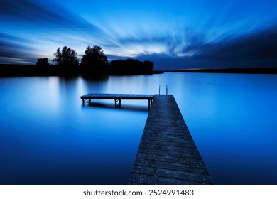 Long Exposure of Wooden Pier by Calm Lake at Dusk - Powered by Shutterstock