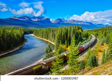 Long freight train moving along Bow river in Canadian Rockies ,Banff National Park, Canadian Rockies,Canada. - Shutterstock ID 1200001987