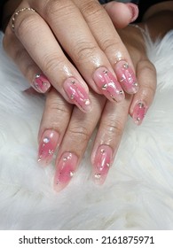 Long gradient nails  light pink  decorated and small diamonds 