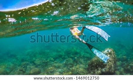 Long Hair Asian Girl with Snorkeling Gear Swimming around Coral Reefs under Open Water Area of South China Sea, near Sanya and Wanning City, Hainan Province. China.