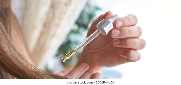 Long Hair Care Routine. Oil For Head. Girl Holding Dropper With Castor Mask Near End. Bathroom Natural Protection