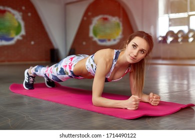 Long Hair Female Doing Plank Static Exercise In Gym Lying On Mat