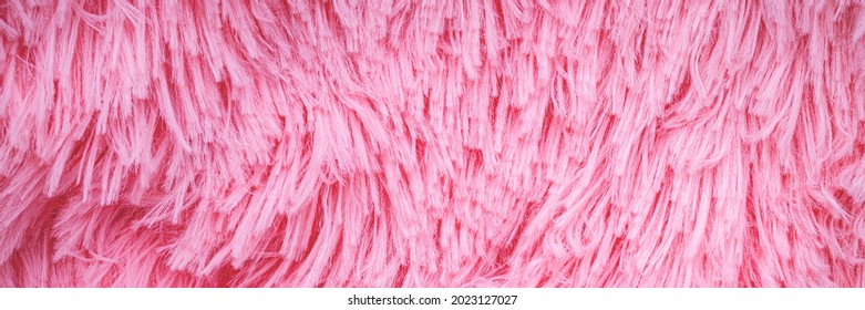 Long Hair Pink Furry Carpet Texture. Banner. Pink Fluffy Fur, Fashion Background. Fashionable Rose Color Fur Texture. Decorative Pink Dyed Sheepskin. Long Hair Rug.