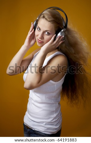 Similar – Young blonde woman listening to music with her headphones