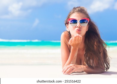 Long Haired Girl In Bikini On Tropical Barbados Beach Blowing Air Kiss