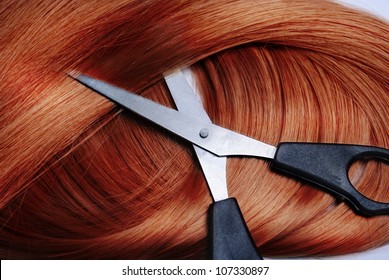 Long healthy red hair and professional scissors - Powered by Shutterstock