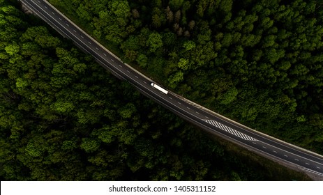 Long Highway Through The Green Forest. Photo From Above Makes By Dron