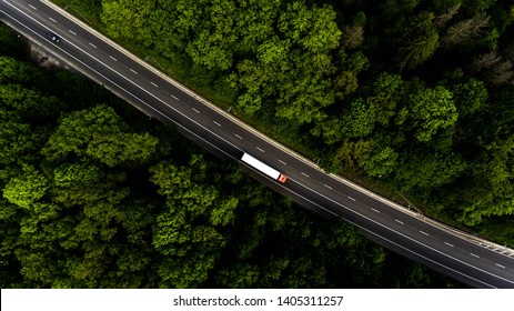 Long Highway Through The Green Forest. Photo From Above Makes By Dron