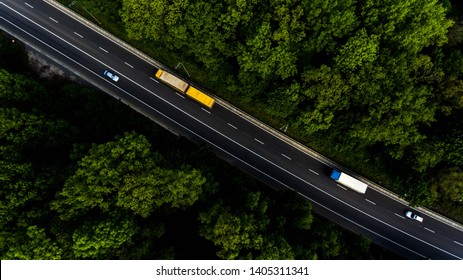 Long Highway Through The Green Forest. Photo From Above Makes By Dron