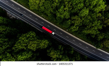 Long Highway Through The Green Forest. Photo From Above Makes By Dron