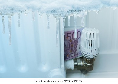 long ice icicles, freezes water, euro banknotes near radiator, temperature regulation in house with thermostat, saving heat, beginning of heating season, freezing, cooling in housing