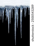 Long icicles on black isolated background