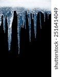 Long icicles on black isolated background