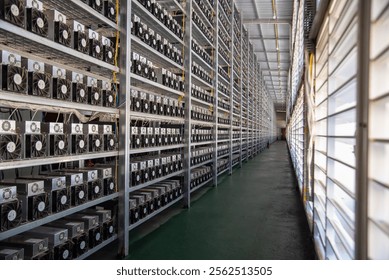 Long industrial corridor with rows of computer servers in a data center, showcasing modern technology and efficient infrastructure.