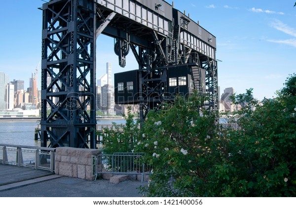Long Island City, New York, USA - June 11, 2019:\
Gantry Plaza State Park located in Long Island City in Queens, NY\
contains a restored railroad car gantry bridge used in the\
industrial past.