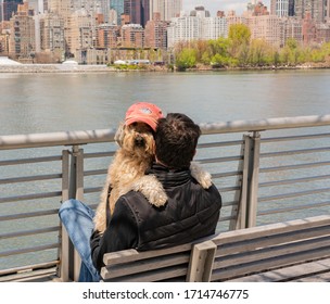 Long Island City, Queens, New York, USA - April 25,2020: Gantry Plaza National Park, Dog And Owner Best Friends Are Sitting On The Bench 