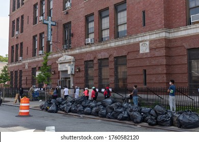 Long Island City Queens, New York / USA - May 26 2020: People In Line At The Evangel Church Food Pantry During The Covid 19 Outbreak In New York City