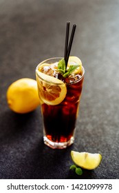 Long Island Cocktail with Lemon Ice Cola Drink. Cool Tea and Rum in Glass on Dark Background. Longdrink Alcohol Soda Brown Hard Drink. Cuba Libre Cocktail Party. Summer Pepsi Refreshing Lemonade