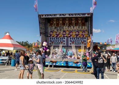 Long Island, New York, USA-September 26, 2021 Games And People At A Carnival 