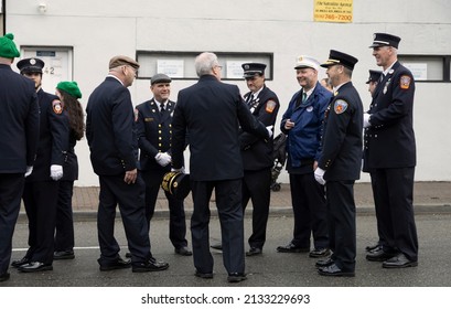 Long Island, NY, USA-A Group Of Firemen Talking During A Saint Patricks Day Parade 