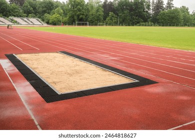 Long jump sand pit and track and field lines in stadium - Powered by Shutterstock