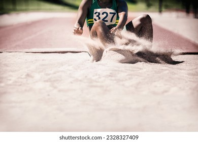 Long jumper landing in sand - Powered by Shutterstock