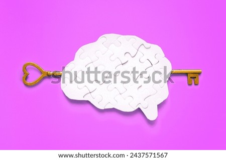 Long key gracefully inserted into a human brain-shaped puzzle, against a soft purple background. Unlocking of brilliance and intellect.