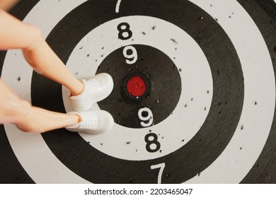 Long Legs Of The Legendary Doll In Sneakers On A Dart Board, Steps To Success Concept, The Path To Success Concept Sports Mood, To The Point, Go To The Goal, Achieve Success