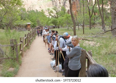 A Long Line Of Park Visitors Waiting For A Shuttle Bus Due To Covid-19 Occupancy Limits At A National Park   Springdale, Utah, USA - May 9, 2021