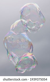 Long lumpy tubular rainbow bubbles against a background of a gray sky with clouds - Shutterstock ID 1939375054