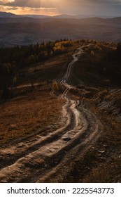 Long Offroad In The Mountains. Autumn Range Landscape During Sunset Time