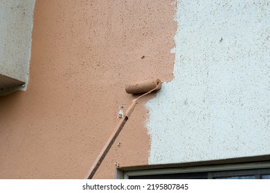 A Long Paint Brush Or Roller Painter Of A Mason Painting And Renovating The Wall Of A Architectural Building To Make It More Beautiful