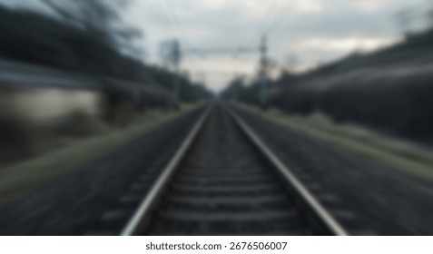 A long perspective of train tracks extending into a blurry, distant landscape, evoking a sense of vastness and quiet contemplation.