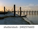 A long pier on a beach in Gulfport, Mississippi during golden hour