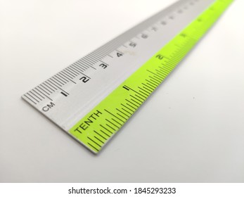 a long plastic ruler with metric and imperial measurements scale. Slightly burred at the back end