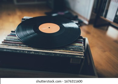 Long play record on stack of vinyl records collection.