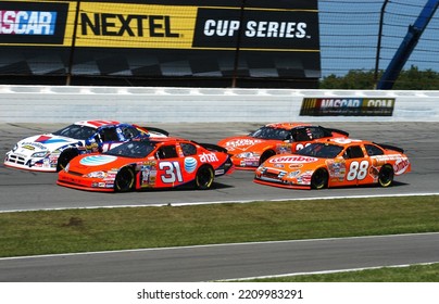 Long Pond, PA, USA - August 5, 2007: A Pack Of Cars Approaches The Green Flag For A NASCAR Cup Series Event At Pocono Raceway In Pennsylvania. Cars Slightly Blurred To Show Speed.