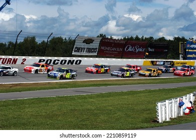 Long Pond, PA, USA - August 3, 2008: A Full Field Of Cars Prepares To Take The Green Flag At A NASCAR Cup Series Race At Pocono Raceway In Pennsylvania. Cars Slightly Blurred To Show Action.