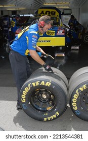 Long Pond, PA, USA - August 1, 2008: A Crewman Scrapes Tires To Remove Debris Following Practice For A NASCAR Cup Series Event At Pocono Raceway In Pennsylvania.