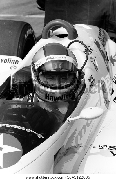Long Pond,\
PA / USA - August 20, 1989: A vintage, old-school black-and-white\
photo of legendary Indy Car driver Mario Andretti in his car at\
Pocono Raceway in\
Pennsylvania.