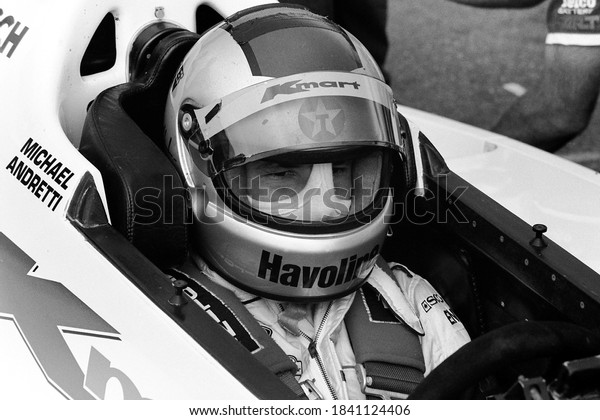 Long Pond, PA /\
USA - August 20, 1989: A vintage, old-school black-and-white photo\
of Indy Car driver Michael Andretti in his car at Pocono Raceway in\
Pennsylvania.